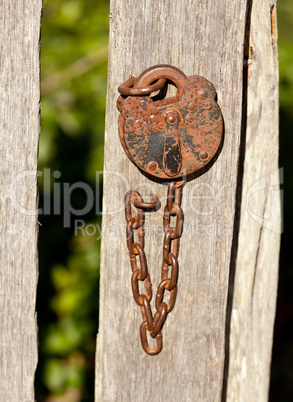 Antique lock and chain on wood