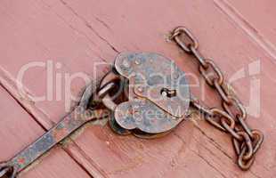Antique lock and chain on wood