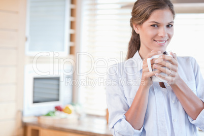 Smiling woman holding a cup of coffee