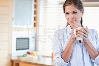 Serene woman holding a cup of coffee
