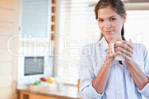 Serene woman holding a cup of coffee