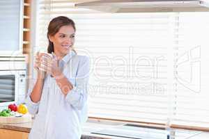 Happy woman holding a cup of coffee