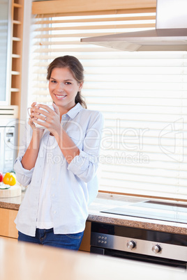 Portrait of a calm woman holding a cup of tea