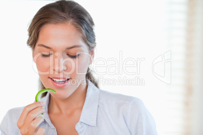 Woman eating a slice of pepper
