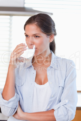 Portrait of a woman drinking a glass of water