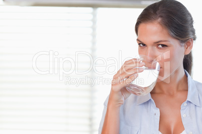 Happy woman drinking a glass of water