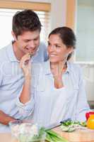 Portrait of a smiling couple cooking