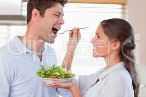 Accomplice couple tasting a salad