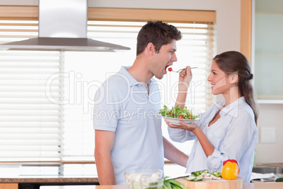 Happy couple tasting a salad