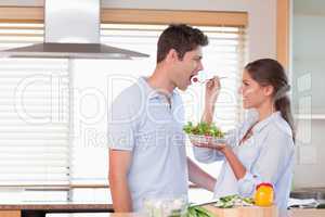 Happy couple tasting a salad
