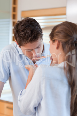 Portrait of a young man tasting his wife's sauce