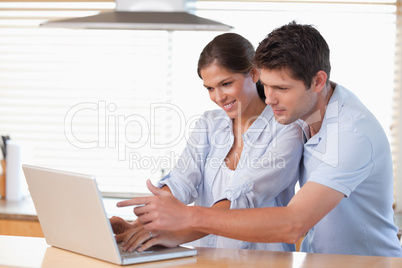 Happy couple using a notebook