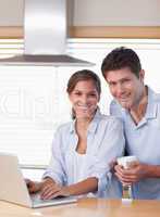 Portrait of a couple using a laptop while having coffee