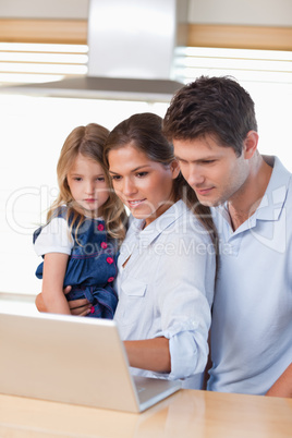 Portrait of a family using a laptop