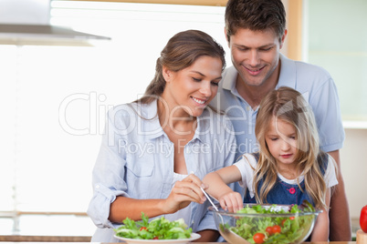 Family preparing a salad