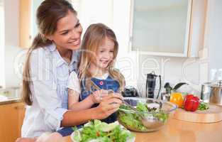 Mother and her daughter preparing a salad