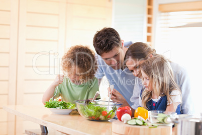 Family preparing a salad together