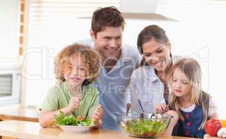 Happy family preparing a salad together