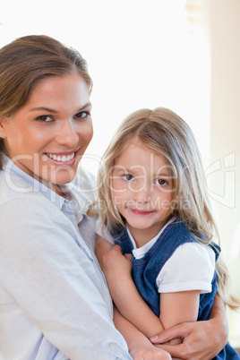 Portrait of a young mother and her daughter posing
