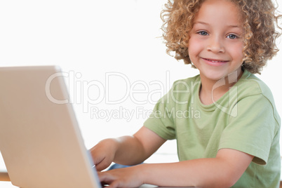 Smiling boy using a notebook