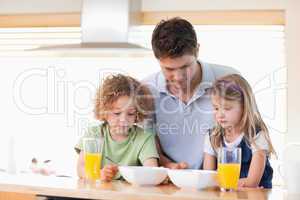Father with his children having breakfast