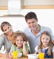Smiling family having breakfast