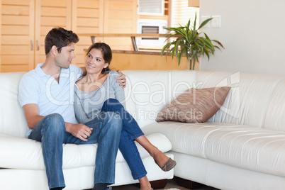 Smiling couple sitting on a couch