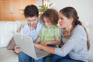 Young family using a notebook
