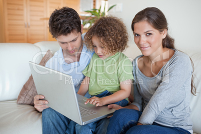 Young family using a laptop