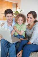 Portrait of a family using a laptop