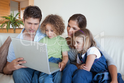 Serene family using a notebook