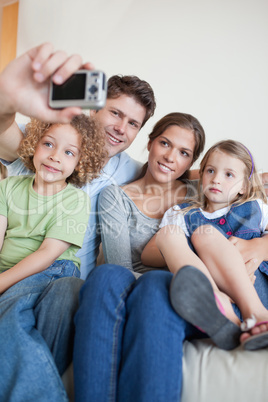 Portrait of a family taking a photo of themselves