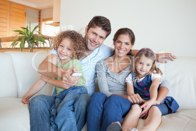 Happy family watching TV together
