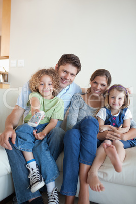 Portrait of a happy family watching TV together