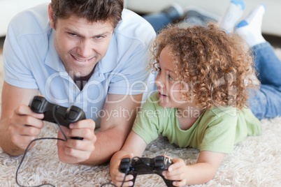 Boy and his father playing video games