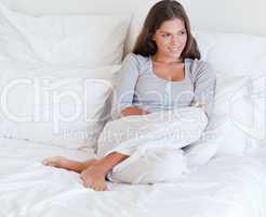 Woman sitting on her bed