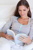 Portrait of an attractive woman reading a book