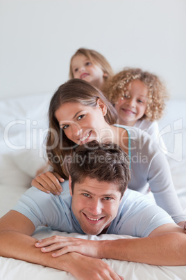 Portrait of a joyful family lying on each other