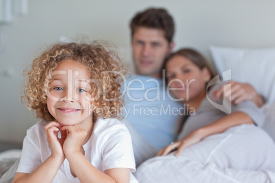Boy sitting on his parents's bed