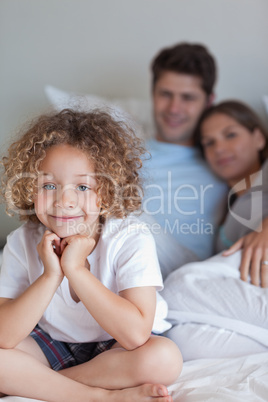 Portrait of a boy sitting on his parents's bed