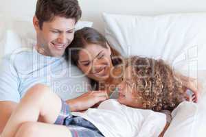 Happy family relaxing on a bed