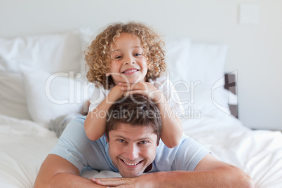 Child lying on fathers back