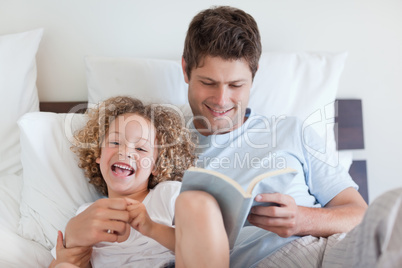 Father reading bedtime story for child