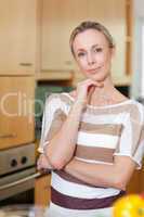 Smiling woman standing in kitchen