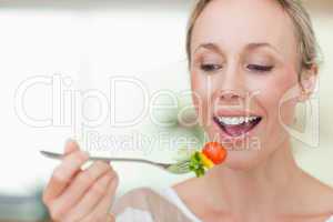 Woman eating a tomato