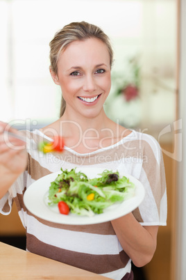 Woman offering salad