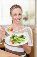 Woman offering salad