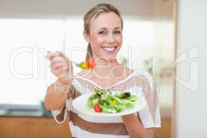 Woman offering healthy salad