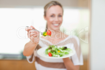 Tomato being offered by woman