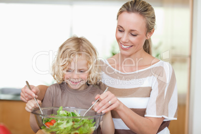 Mother and son preparing salad